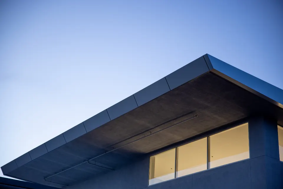 Modern roofline against a clear blue sky